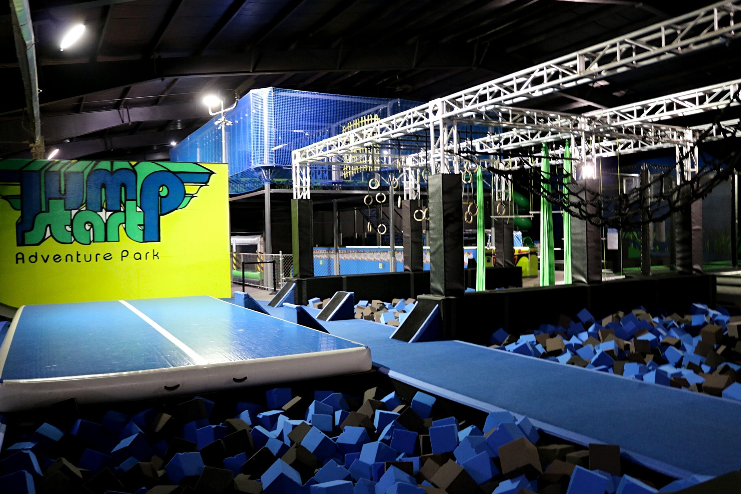 A man jumping on the side of a trampoline.